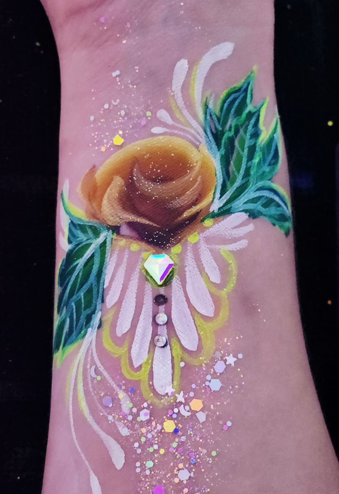 Airbrushed rose with gold and white petals, green leaves and a jewel accent